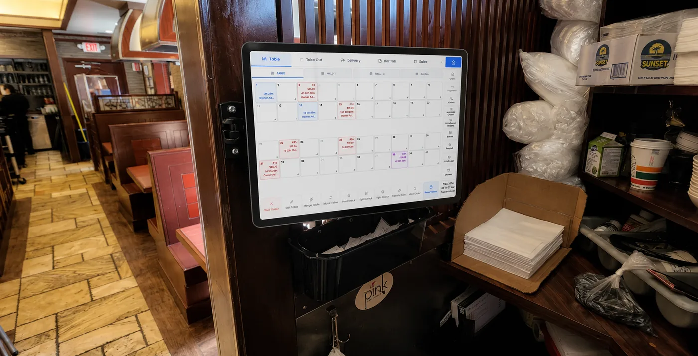 A wall-mounted service-station terminal showing the Branch Eats table map