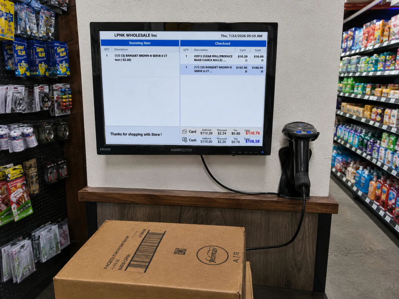 A wall-mounted screen and barcode scanner in a grocery aisle